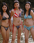 Three asian beach babes pose in sexy bikinis